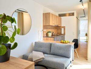 uma sala de estar com um sofá e uma cozinha em Modern ausgebauter Überseecontainer als Tiny House em Wertheim