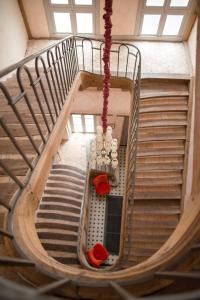 a spiral staircase in a building with red seats at Maison Ailleurs in Chartres