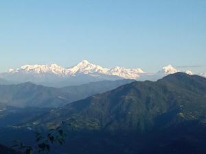 a view of a mountain range with snow covered mountains at Tragopan Homestay in Aritar