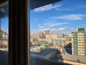 a view of a city skyline from a window at K Hostel in Ulaanbaatar