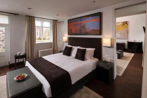 a bedroom with a large bed and a large window at Penrhiw Priory in St. Davids