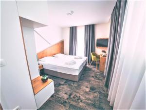 Krevet ili kreveti u jedinici u objektu Orange Hotel