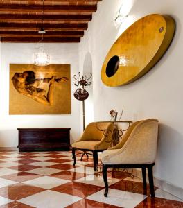 a living room with two chairs and a surfboard on the wall at La Corte Dei Sogni B&B in Modena