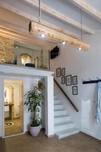 a staircase in a living room with a mirror at Classic Corfiot Town House in Corfu