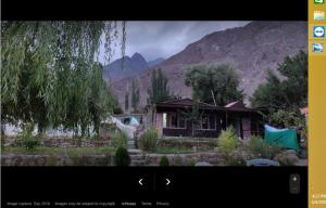 a picture of a house with a statue in front of it at Hunza Huts Duikar Altit in Baltit
