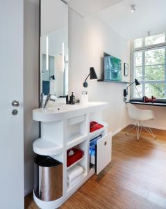 a bathroom with a sink and a mirror at citizenM Amstel Amsterdam in Amsterdam