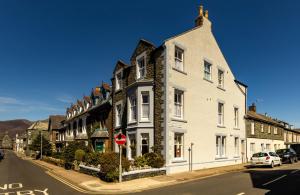 a row of houses on a street with a stop sign at Dorchester House in Keswick