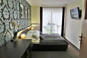 Una cama o camas en una habitación de Pensjonat Albatros Pogorzelica