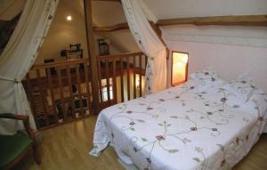 a bedroom with a bed with a white comforter at la roseraie in Caumont +1 photo