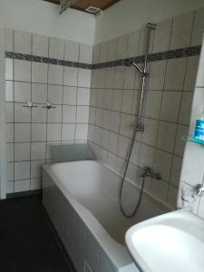 a bathroom with a bath tub with a shower at Ländliche Erholung 3 in Heideland