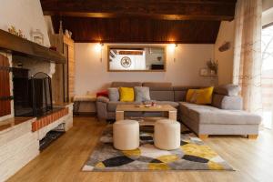 a living room with a couch and a table at Holiday Home Vanda in Zlobin