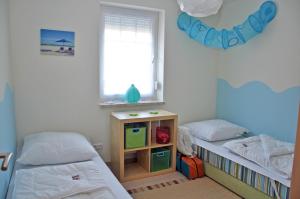 Postel nebo postele na pokoji v ubytování Ferienhaus Müritzbrise / EG-Appartement