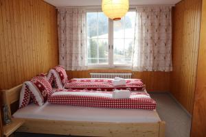 a bedroom with two beds in front of a window at Galluszentrum in Wildhaus