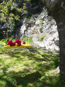 a swing with flowers on it in a yard at Villa in Sintra - Casa da Penha Ferrim in Sintra