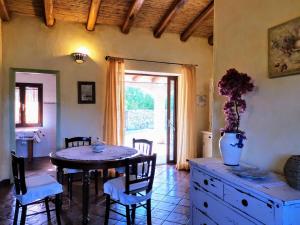 a dining room with a table and chairs in a room at Villa La Quercia - Capriccioli in Abbiadori