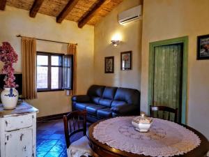 a living room with a table and a couch at Villa La Quercia - Capriccioli in Abbiadori