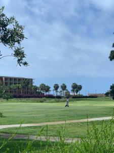 a person riding a scooter on a golf course at Salgados Beach&Golf - Praia dos Salgados in Albufeira