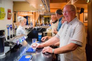 a group of people standing at a bar at Barrowfield Hotel in Newquay +58 photos