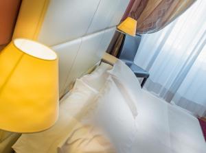 Кровать или кровати в номере Hotel Ligure