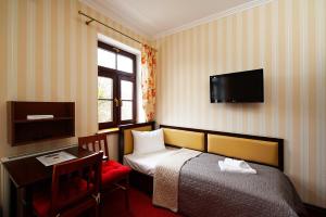 Postel nebo postele na pokoji v ubytování Hotelik & Restauracja Złota Kaczka