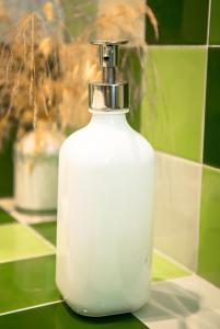 a white soap dispenser sitting on a counter at Apartamentos Bergantes in Ortells