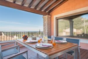 een tafel op een terras met uitzicht op de oceaan bij Villa Del Carmen Sis - Sunset Villa Furios Petit in Selva
