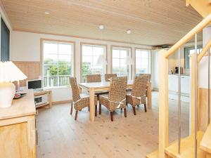 a dining room with a table and chairs at 6 person holiday home in L s in Læsø