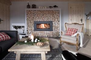 a living room with a couch and a fireplace at Villa Miodula in Kościelisko