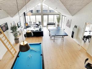 a large living room with a ping pong table at Holiday home Grenaa XI in Grenå