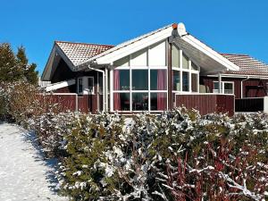 a house with snow in front of it at 6 person holiday home in Otterndorf in Otterndorf