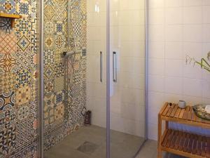 a shower with a glass door in a bathroom at Holiday home ÖDESHÖG in Ödeshög