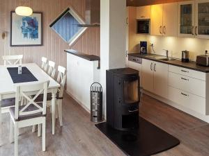 a kitchen with a table and a stove in it at 8 person holiday home in Gelting in Gelting