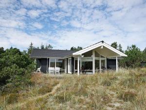 a small house on top of a hill at Three-Bedroom Holiday home in Jerup 8 in Jerup