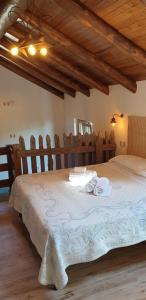 a bedroom with a large bed with towels on it at Agriturismo Mare e Monti in Agerola