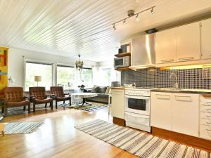 a kitchen and living room with a table and chairs at Two-Bedroom Holiday home in Hallabro 3 in Hallabro