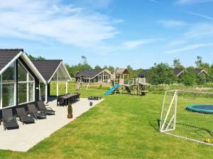 a large yard with a playground with a goal at 14 person holiday home in Idestrup in Bøtø By