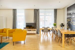 sala de estar con mesa y sillas amarillas en Big City Aprtment in Berlin-Friedrichshain, en Berlín