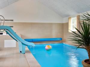 a indoor pool with a slide in a room at 18 person holiday home in Tisvildeleje in Tisvildeleje