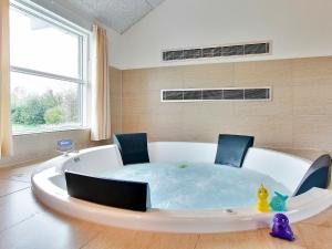 a bath tub with two chairs in a bath room at 18 person holiday home in Tisvildeleje in Tisvildeleje