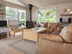 a living room with a couch and a coffee table at 6 person holiday home in R nde in Rønde