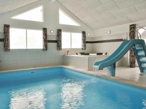 a swimming pool with a slide in a bathroom at 22 person holiday home in Harbo re in Harboør