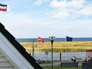 a view of the ocean from a house with flags at 6 person holiday home in Wendtorf in Wendtorf