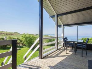 a patio with a table and chairs on a deck at 7 person holiday home in Struer in Remmer Strand