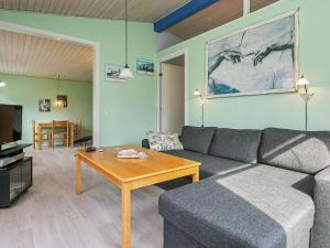 a living room with a couch and a coffee table at 8 person holiday home in Stege in Stege