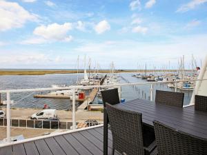a deck with chairs and a marina with boats at 6 person holiday home in Wendtorf in Wendtorf
