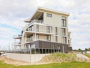 a tall building with a fence in front of it at 8 person holiday home in Wendtorf in Wendtorf