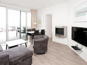 a living room with a couch and chairs and a television at 4 person holiday home in Wendtorf in Wendtorf