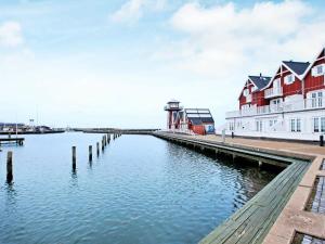 a body of water with houses and a lighthouse at 6 person holiday home in Bagenkop in Bagenkop