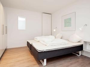 a bed in a room with white walls at One-Bedroom Holiday home in Wendtorf 11 in Wendtorf