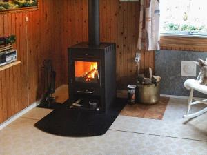 a living room with a stove in a room at 5 person holiday home in Silkeborg in Silkeborg